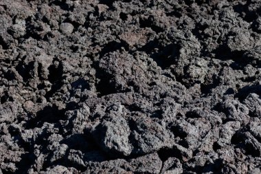 Black stone texture of volcanic porous stones from recent volcanic activity.