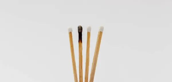 stock image matches burned to symbolize burnout syndrome and mental illness.