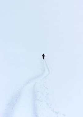 Kar ayakkabısı, yalnızlık ve yalnızlık kavramını gösteren bir hiçliğe doğru yürüyor..