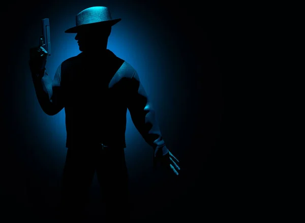 stock image 3d render noir illustration of shaded detective posing with gun and hat on dark blue background.