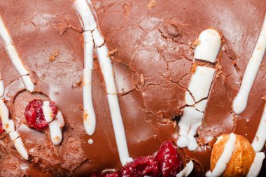 Close up photo texture of cracked chocolate and dried fruits.