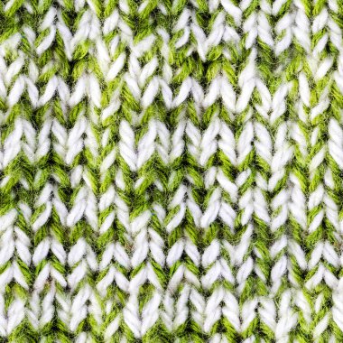 Yeşil ve beyaz renkli örülmüş yün kazak kumaşının kusursuz 4k fotoğraf dokusu.