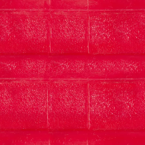 Kırmızı renkli yıpranmış plastik yüzeyin kusursuz 4k fotoğraf dokusu..