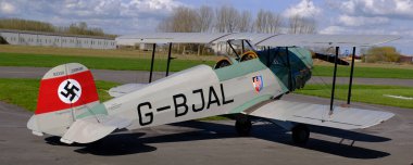 Breighton, Selby, Yorkshire, UK. April 2024. The Bcker B 131 Jungmann is a basic biplane trainer aircraft design and produced by the German aircraft manufacturer Bcker Flugzeugbau.  clipart