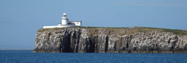 The Farne Islands are a group of islands off the coast of Northumberland, England. The group has between 15 and 20 islands depending on the level of the tide. clipart