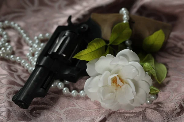 white beautiful rose with pearls and gun. romantic. copy space