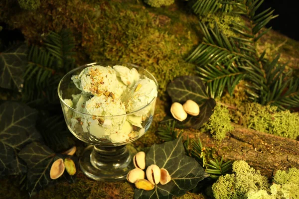 pistachio ice cream with nuts on green nature  background