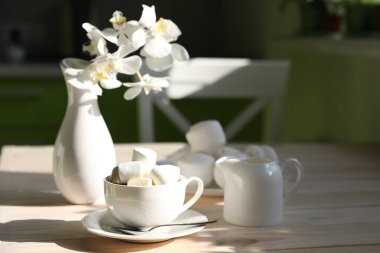 breakfast with black coffee, milk and marshmallow on white background