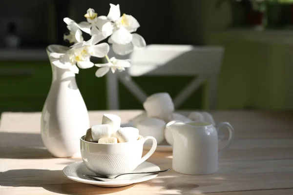 breakfast with black coffee, milk and marshmallow on white background