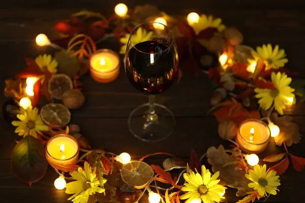 glass of red wine with autumn decoration