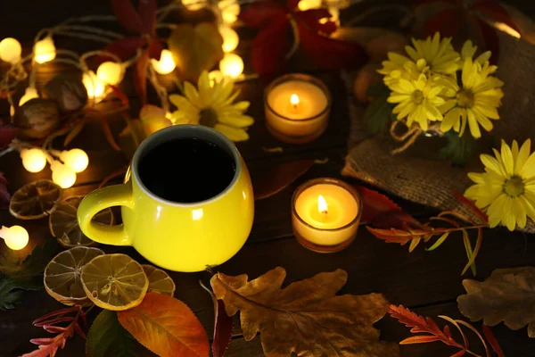 cup of coffee on the autumn background with leaves and flowers 
