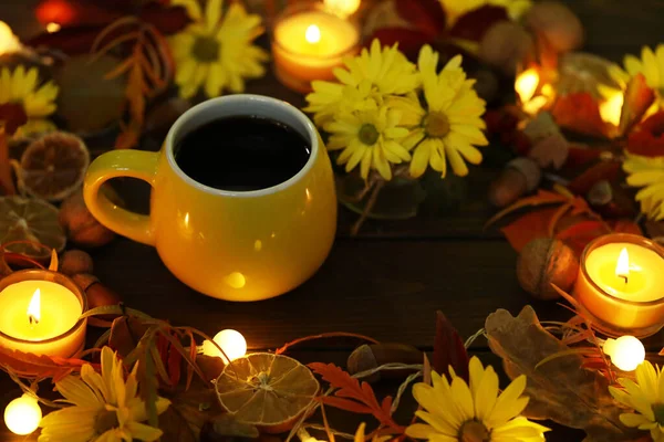 cup of coffee on the autumn background with leaves and flowers 