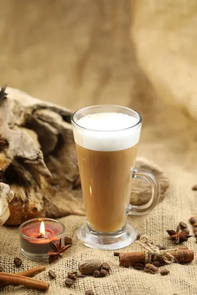 Glass coffee with spices. Cloth background with copy space