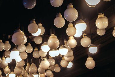 Koyu arkaplanda ampuller. Bokeh efektli parlayan ışıklar