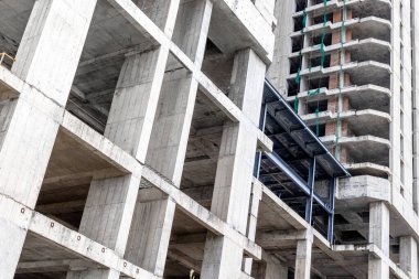 Açığa çıkan beton ve çelik yapılarla tamamlanmamış gökdelen inşaatı.