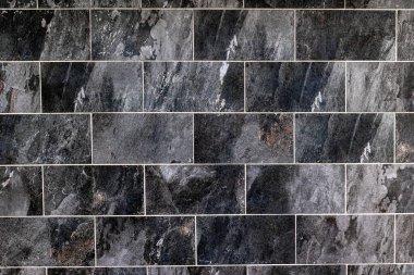 Doğal dokusu ve değişen gri tonlarıyla koyu renkli döşeme duvarı..