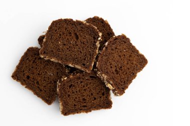 slices of rye bread on white background, top view, heap of fresh delicious homemade healthy baking