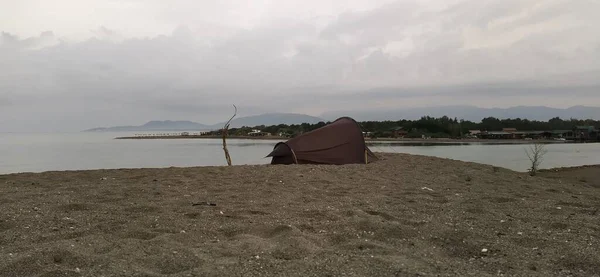 a beautiful shot of a beach with a tent and sea. Montenegro