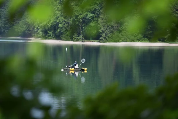 boot wiht a man on the like. walchensee. bayern. bavaria. germany