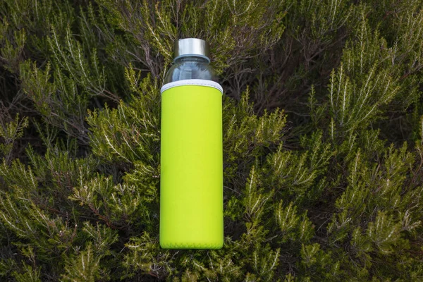 stock image green water bottle on a wooden background