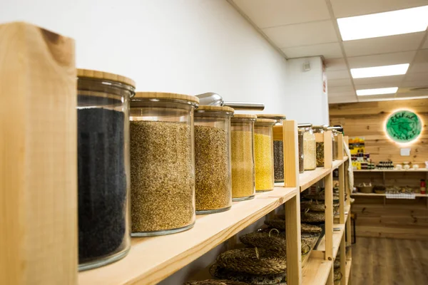 stock image Self service bulk organic food. Eco-friendly zero waste shop. Small local business. Peeled millet, natural sesame, toasted sesame and black sesame.