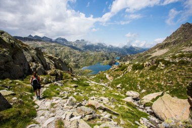 Young girl summit to Ratera Peak in Aiguestortes and Sant Maurici National Park, Pyrenees, Spain