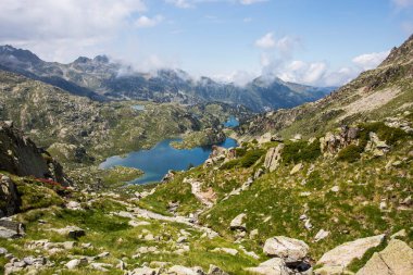 Young girl summit to Ratera Peak in Aiguestortes and Sant Maurici National Park, Pyrenees, Spain