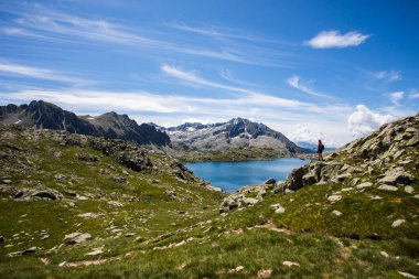 Young hiker girl summit to Montardo Peak in Aiguestortes and Sant Maurici National Park, Pyrenees, Spain.