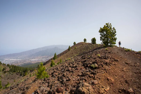 stock image A young woman walking towards Birigoyo peak, La Palma Island, Canary Islands, Spain.