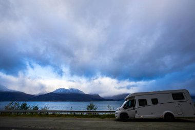 Norveç 'in Lyngen Alpleri' nin sonbahar manzarasında yol kenarına parketmiş bir karavan..