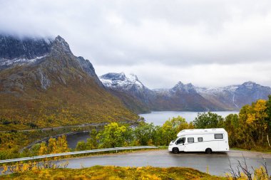 Norveç 'in Senja Adası' nın sonbahar manzarasında, fiyortları ve dağları olan bir karavan..