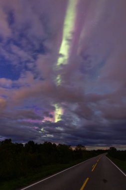 The stunning Northern Lights over Lofoten Islands, northern Norway, with vivid colors lighting up the night sky above mountains. clipart