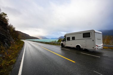 Norveç 'in Lyngen Alpleri' nin sonbahar manzarasında yol kenarına parketmiş bir karavan..