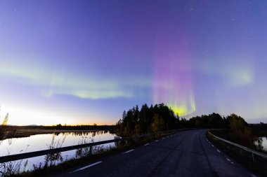 İsveç 'in Kiruna kentindeki kuzey ışıkları Eylül ayında sakin suları yıldızlar ve ormanlarla yansıtıyor..