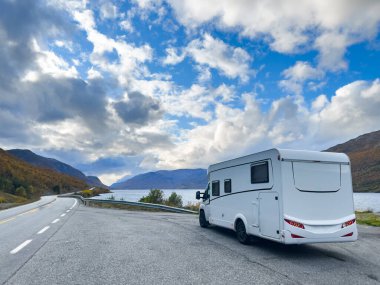 Norveç 'in Lyngen Alpleri' nin sonbahar manzarasında yol kenarına parketmiş bir karavan..