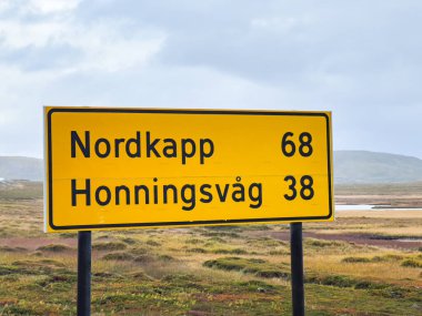 Kuzey Norveç 'teki Nordkapp ve honningsvag' a olan mesafeleri gösteren sarı yol işareti.