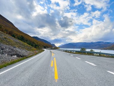 Norveç 'in Lyngen Alpleri' nin sonbahar manzarasında yol kenarına parketmiş bir karavan..