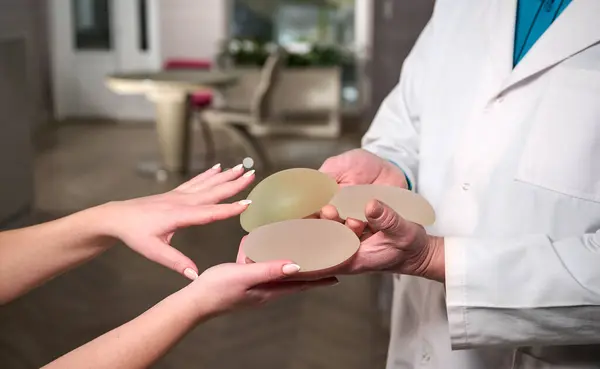 Close Female Plastic Surgeon Demonstrates Breast Implants Patient Her New Stock Photo