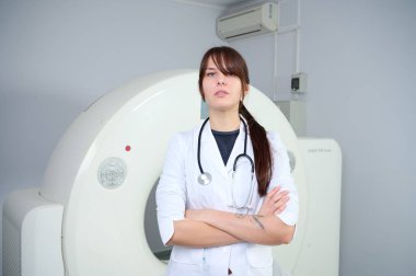 Genç bayan radyologlar tomografi odasında kalıyorlar. Klinikte çalışıyorum. Güzel doktor röntgen, röntgen, tomografi ve MRI 'ya bakıyor. Üniformalı doktor.