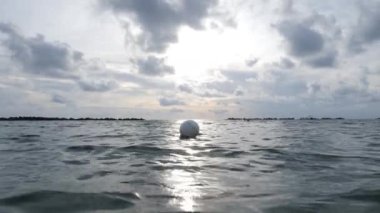 Buoy floating on sea surface. Swimming restriction in deep water
