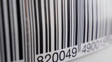 Barcode label scanning with red laser strip. Production line, close up shot
