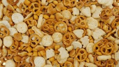 Salted pretzels, biscuit crackers. Crispy salty snacks in various forms, view from top