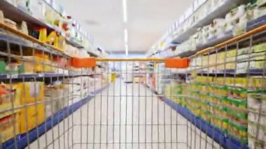 Shopping trolley, POV time warp. Buyer is looking for goods in the supermarket