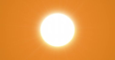 Evening sun in the orange sky. The sun shines brightly on a clear, cloudless horizon. Seamless loop