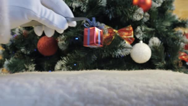Santa Claus Hand Puts Little Gift Tweezers Decorated Christmas Tree — Stock Video