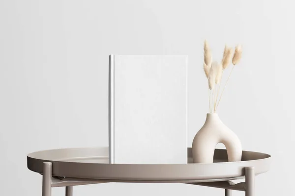 stock image White book mockup with a lagurus decoration on the beige table.