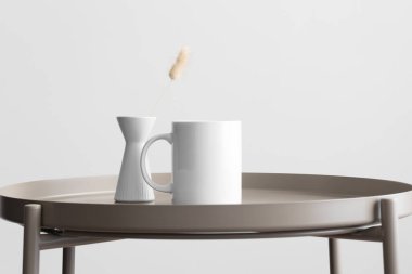 Beyaz kupa modeli ve bej masa üzerinde lagurus süslemesi..