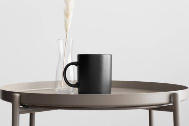 Siyah kupa modeli ve bej masa üzerinde pampa süslemesi..