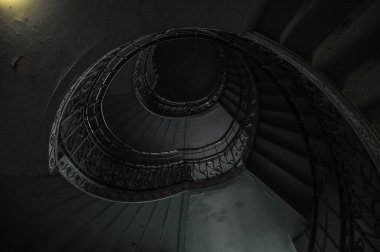 Green staircase with winding stairs, natural delicate light dark