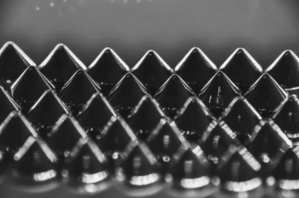 stock image Close-up macro of sewing studs arranged in symmetrical rows in black and white abstraction